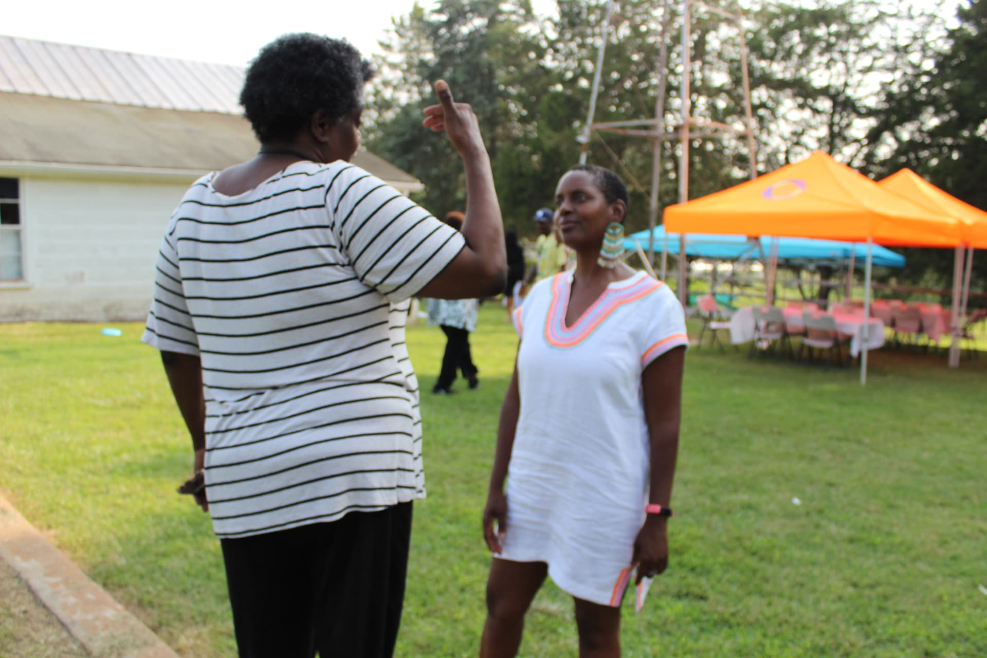 Two neighbors talking during a community gathering