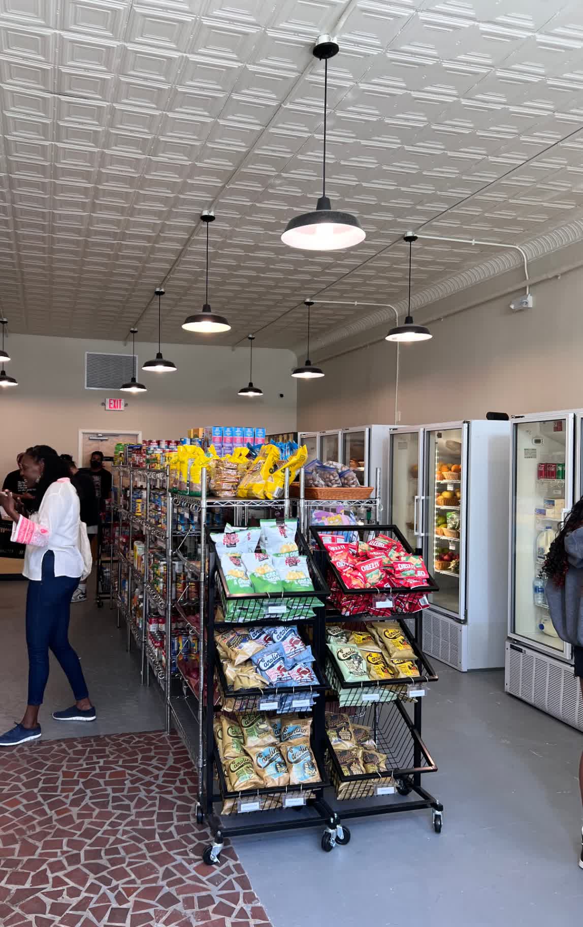 Fresh produce and refrigerated cases inside the East Durham Market