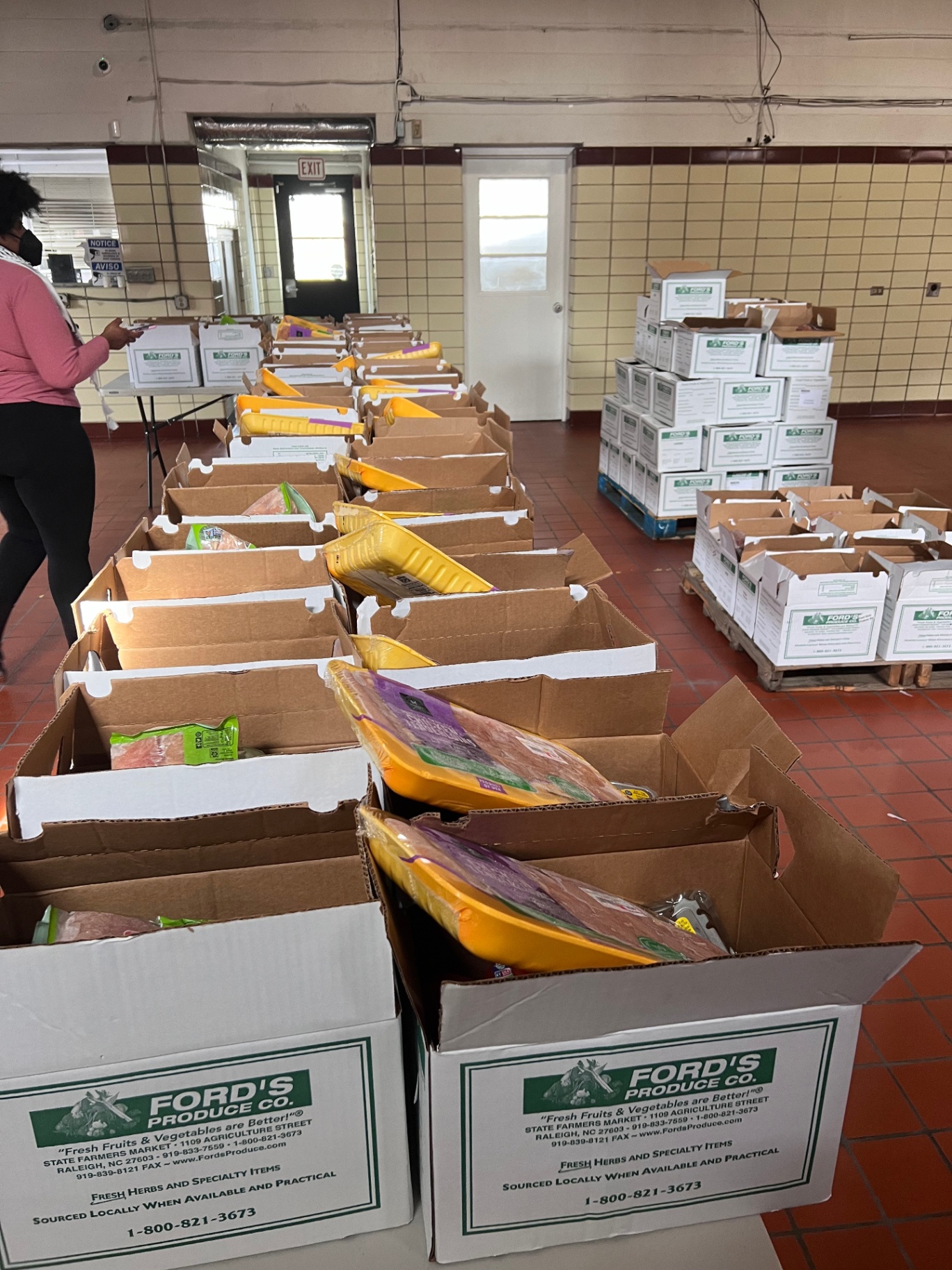 Boxes of fresh produce set out for neighbors at a free distribution